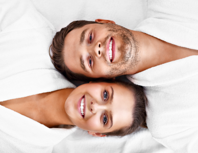 Close-up of a woman getting hair highlights with foil and dye brush.