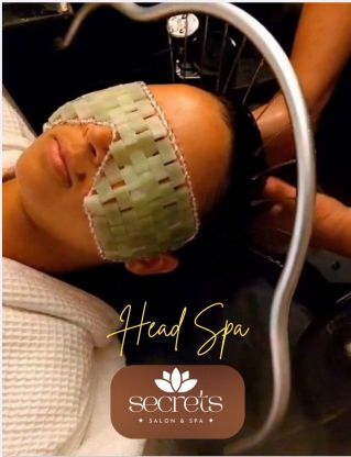Relaxing spa treatment with facial and sponge massage in a serene environment.