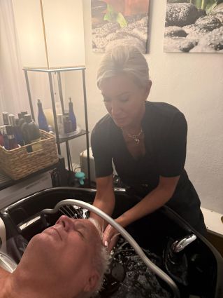 Relaxing spa treatment with facial and sponge massage in a serene environment.